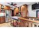 Well-lit kitchen featuring wood cabinets, stainless steel appliances, and a marble-top kitchen island at 3145 W 31St Ave, Denver, CO 80211