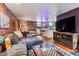 Recreational room featuring exposed brick, tv, with comfortable sectional couch at 3145 W 31St Ave, Denver, CO 80211