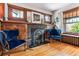 Living room featuring a decorative fireplace with wooden trim and traditional windows at 3145 W 31St Ave, Denver, CO 80211