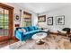 Cozy living room featuring a blue sectional, plush rug, and ample natural light at 3145 W 31St Ave, Denver, CO 80211