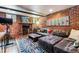 Spacious living room features exposed brick, fireplace, and comfortable seating at 3145 W 31St Ave, Denver, CO 80211