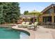 Luxury backyard oasis featuring a sparkling pool, outdoor dining area, and lush landscaping at 3401 E Kentucky Ave, Denver, CO 80209