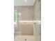 Modern bathroom featuring a glass-enclosed shower with pebble flooring and sleek tile walls at 3401 E Kentucky Ave, Denver, CO 80209