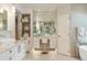 Spa-like bathroom with a vanity, large mirrors, and a separate makeup area at 3401 E Kentucky Ave, Denver, CO 80209