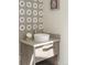 Stylish powder room featuring a round vessel sink, modern floral wallpaper, and a gray vanity at 3401 E Kentucky Ave, Denver, CO 80209