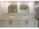 Bright bathroom featuring double sinks, sleek cabinetry, and modern fixtures at 3401 E Kentucky Ave, Denver, CO 80209