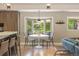 Bright breakfast nook with a bay window, comfortable seating, and natural light at 3401 E Kentucky Ave, Denver, CO 80209