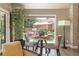 Dining area features a glass table set, large window, and view of the outdoor patio at 3401 E Kentucky Ave, Denver, CO 80209