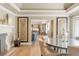 Open-concept dining room with fireplace, glass table and chairs, and open view to kitchen at 3401 E Kentucky Ave, Denver, CO 80209