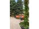 Inviting outdoor space featuring a stone firepit, comfortable seating, and lush greenery at 3401 E Kentucky Ave, Denver, CO 80209