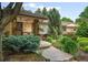 Inviting front entrance with stone accents, a concrete walkway, and a manicured garden at 3401 E Kentucky Ave, Denver, CO 80209