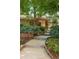 Front entrance with stone accents, a concrete walkway, and lush landscaping at 3401 E Kentucky Ave, Denver, CO 80209