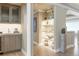 Hallway with built-in bar, decorative shelves, and elegant lighting at 3401 E Kentucky Ave, Denver, CO 80209