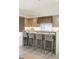 Kitchen with seating at the island, modern cabinetry, and stylish lighting at 3401 E Kentucky Ave, Denver, CO 80209
