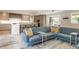 Open-concept living room featuring a large sectional sofa, and modern decor at 3401 E Kentucky Ave, Denver, CO 80209