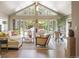 Bright living room with high ceilings, large windows, and access to the backyard patio and pool at 3401 E Kentucky Ave, Denver, CO 80209