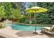 Lush backyard featuring a sparkling pool, waterfall feature, and ample seating at 3401 E Kentucky Ave, Denver, CO 80209