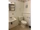 A bathroom with a sink, toilet, shelf and mirror at 11318 Clermont Dr, Thornton, CO 80233