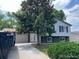 Two-story home with mature landscaping, light siding, and a driveway leading to an attached garage at 11318 Clermont Dr, Thornton, CO 80233