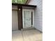 Front door with sidelight, storm door, and adjacent 2-car garage at 11318 Clermont Dr, Thornton, CO 80233