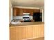 The kitchen features wood cabinets, black appliances, and an island at 11318 Clermont Dr, Thornton, CO 80233