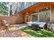 Cozy back patio area with outdoor seating, wooden accents, and an area of green artificial turf at 2640 Central Ct # 104, Denver, CO 80211