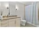 Bathroom featuring a vanity with modern fixtures and a shower with tile surround at 2640 Central Ct # 104, Denver, CO 80211