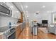 Modern kitchen with stainless steel appliances and an island in an open floorplan at 2640 Central Ct # 104, Denver, CO 80211
