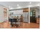 Modern kitchen featuring stainless steel appliances, a stylish island, and wood cabinets at 2640 Central Ct # 104, Denver, CO 80211