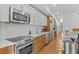 Stylish kitchen showcasing stainless steel appliances, light and wood cabinets and countertops at 2640 Central Ct # 104, Denver, CO 80211