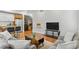 Comfortable living room showing the kitchen, a sleek TV, and modern furniture at 2640 Central Ct # 104, Denver, CO 80211
