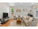 Comfortable living room featuring modern decor, neutral tones, and hardwood flooring at 2640 Central Ct # 104, Denver, CO 80211