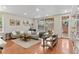 Open living space with hardwood floors, neutral-toned furniture, and bright, natural light at 2640 Central Ct # 104, Denver, CO 80211