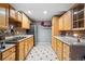 Basement kitchen with wood cabinets and mosaic tile backsplash at 1586 S Field Ct, Lakewood, CO 80232