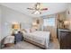 Bright bedroom with a queen-size bed, dresser, and ceiling fan at 1586 S Field Ct, Lakewood, CO 80232