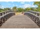 Wooden footbridge over a tranquil waterway at 1586 S Field Ct, Lakewood, CO 80232