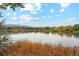 Scenic lake view with fall foliage and mountains at 1586 S Field Ct, Lakewood, CO 80232