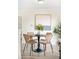 Cozy dining area featuring a round table, four chairs, and stylish decor at 2635 Kearney St, Denver, CO 80207