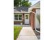Close-up of the inviting front door, showcasing the brick facade and a well-maintained walkway at 2635 Kearney St, Denver, CO 80207