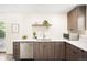Modern kitchen with stainless steel appliances, white countertops and wood cabinets at 2635 Kearney St, Denver, CO 80207
