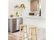 Charming kitchenette with bar-stool seating, modern stainless-steel appliances, and stylish countertops at 2635 Kearney St, Denver, CO 80207