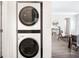 Convenient laundry area with stacked washer and dryer and access to the living room at 2635 Kearney St, Denver, CO 80207