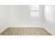 Minimalist room featuring a light-filled atmosphere, wood floors, and a window at 2635 Kearney St, Denver, CO 80207
