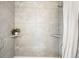 Modern shower with gray tiled walls, shower head, and recessed shelves at 2635 Kearney St, Denver, CO 80207