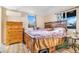 Bedroom featuring a wooden dresser, wooden bed frame, purple comforter, wood flooring and a window at 3930 W Kentucky Ave, Denver, CO 80219