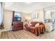 Cozy living room features hardwood floors, a comfortable couch, and bright natural light at 3930 W Kentucky Ave, Denver, CO 80219