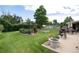 Beautifully landscaped backyard with a manicured lawn, flower garden, and outdoor seating area at 6666 S Pennsylvania St, Centennial, CO 80121