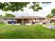 Large backyard with a spacious patio, outdoor dining furniture, and mature landscaping at 6666 S Pennsylvania St, Centennial, CO 80121