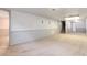 Large basement with neutral carpet, wainscotting and a glimpse of carpeted stairs at 6666 S Pennsylvania St, Centennial, CO 80121