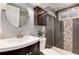 Modern bathroom boasts tiled shower with glass, updated vanity, and brushed-nickel fixtures at 6666 S Pennsylvania St, Centennial, CO 80121